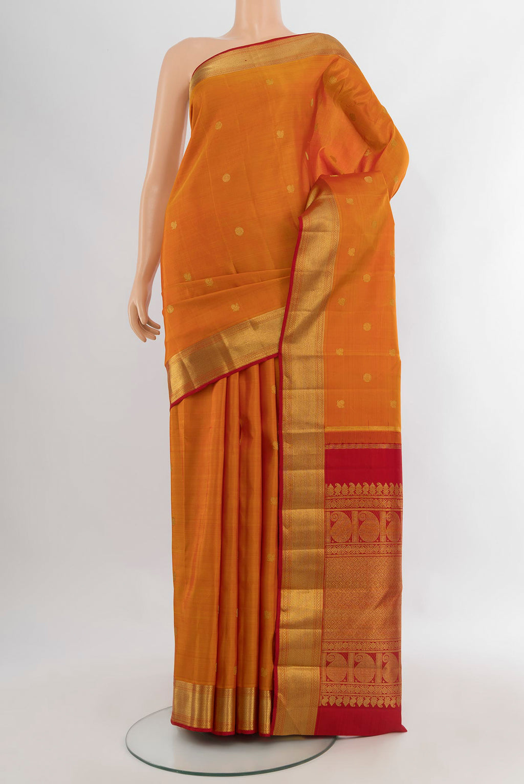 Pure Silk Pure Zari Mustard Kanjivaram Saree with Zari Butta on the body and Zari Border.  displayed on a mannequin