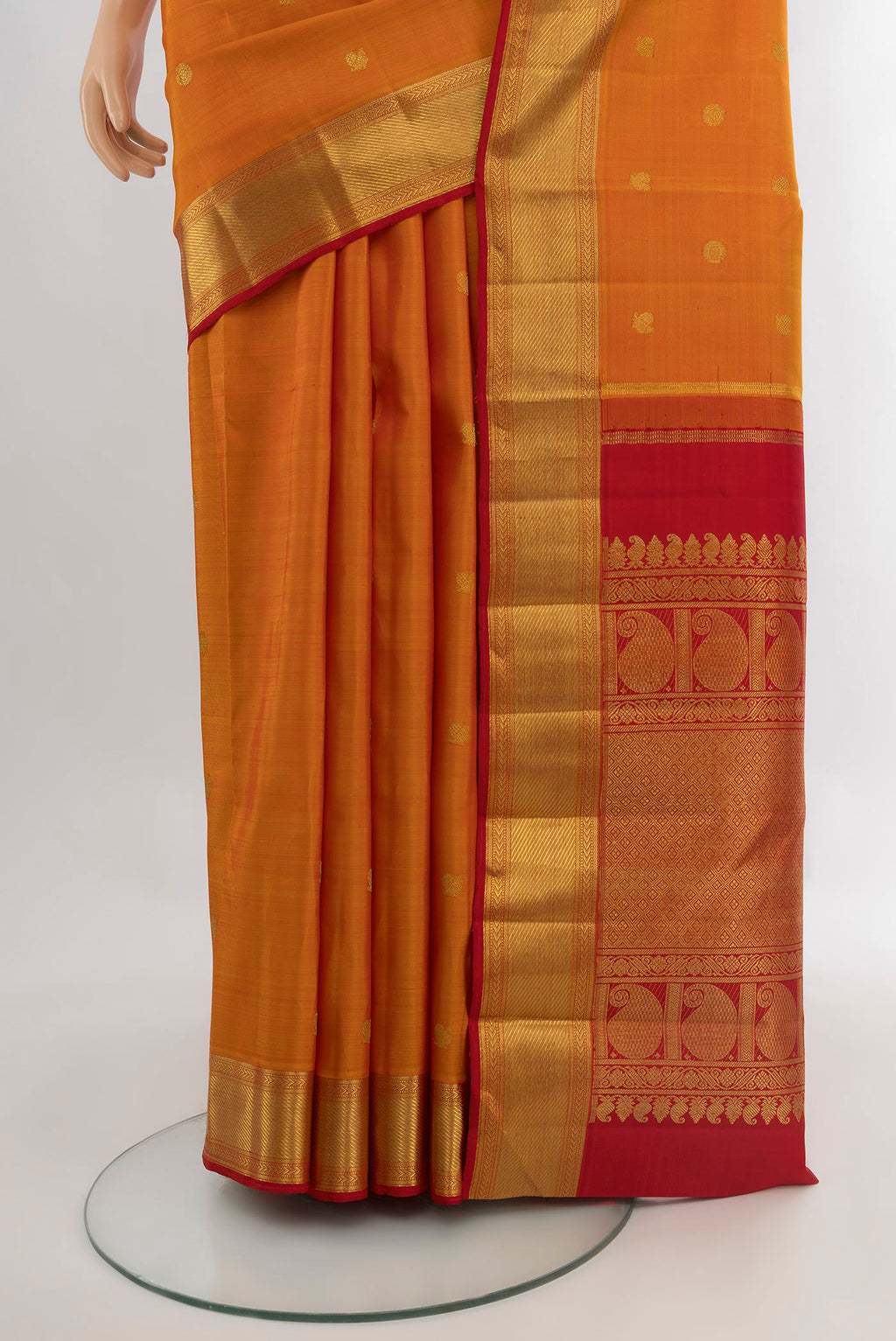 Pleats and pallu of Pure Silk Pure Zari Mustard Kanjivaram Saree with Zari Butta on the body and Zari Border. 