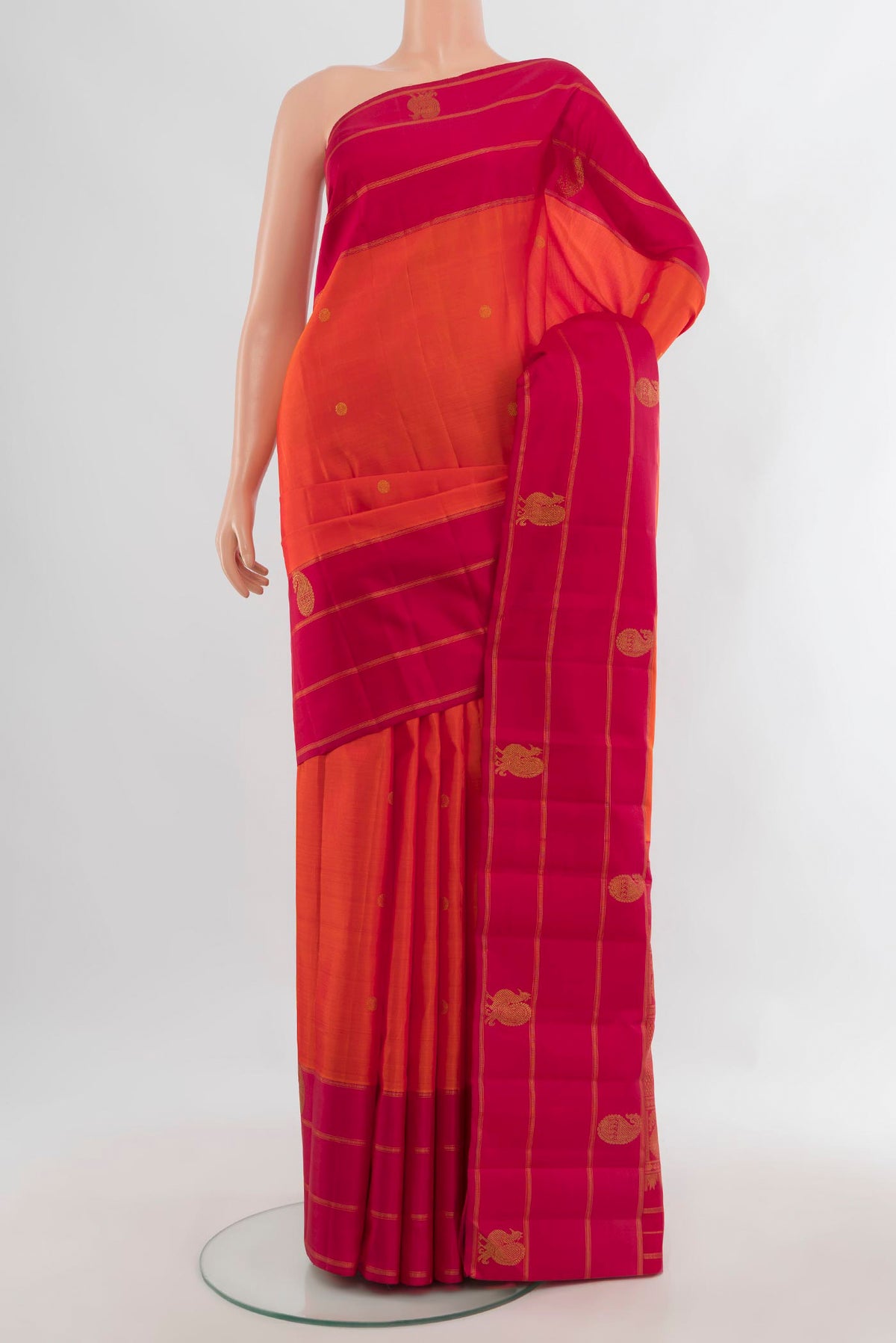 Pure Silk Pure Zari Orange Kanchipuram Saree with Zari Butta on the body and Plain Border.  displayed on a mannequin