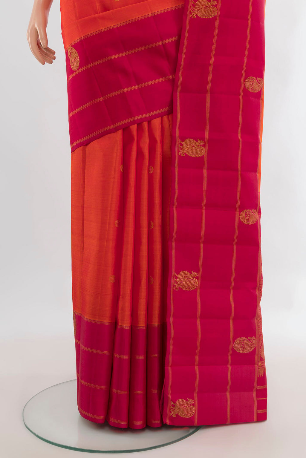 Pleats and pallu of Pure Silk Pure Zari Orange Kanchipuram Saree with Zari Butta on the body and Plain Border. 