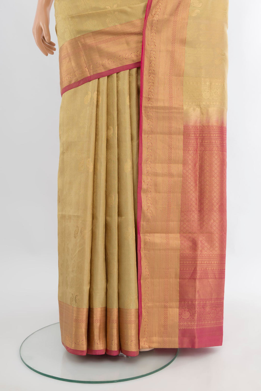Pleats and pallu of Beige Soft Silk Saree with Zari Butta on the body and Zari Border. 