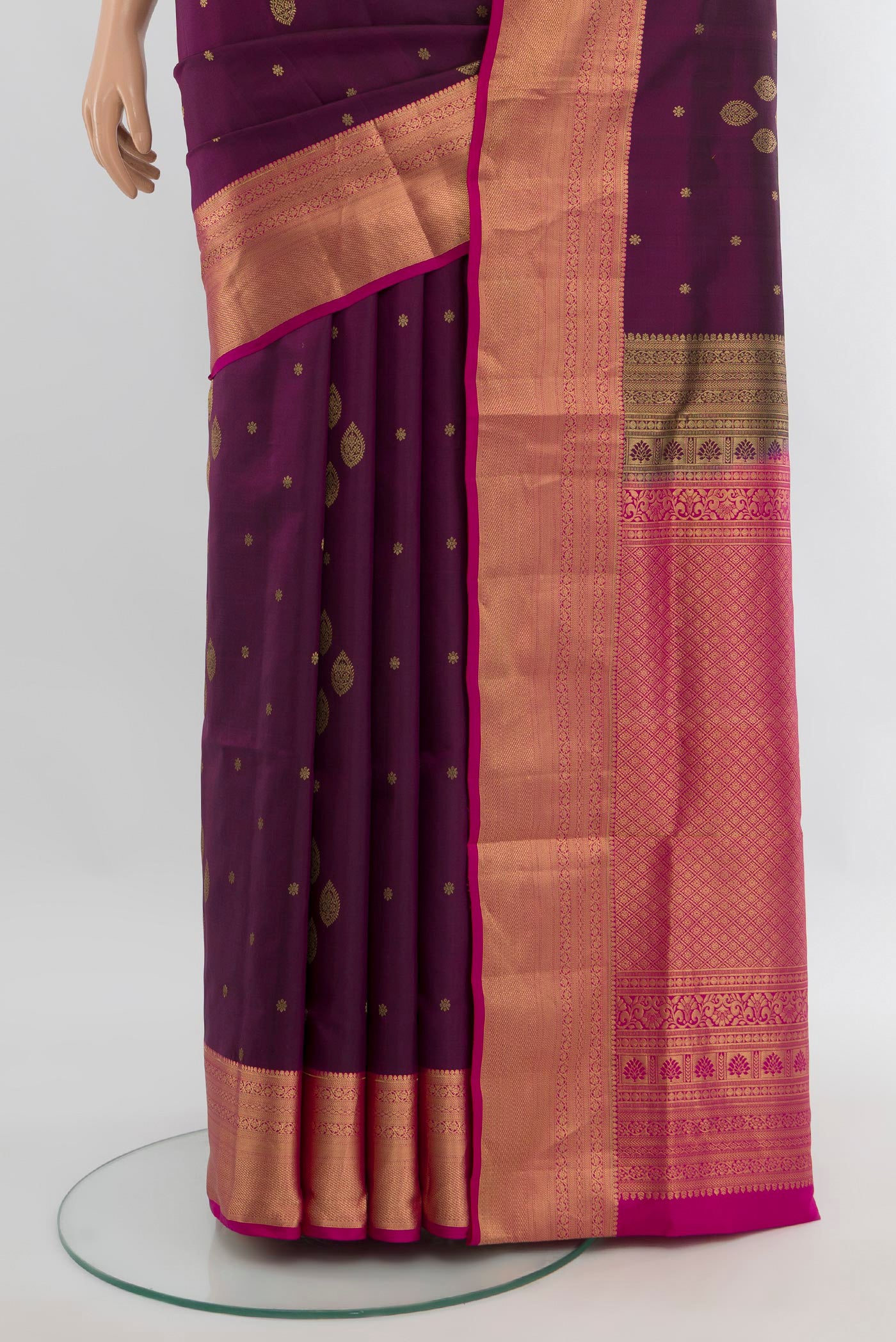 Pleats and pallu of Purple Soft Silk Saree with Zari Butta on the body and Zari Border. 