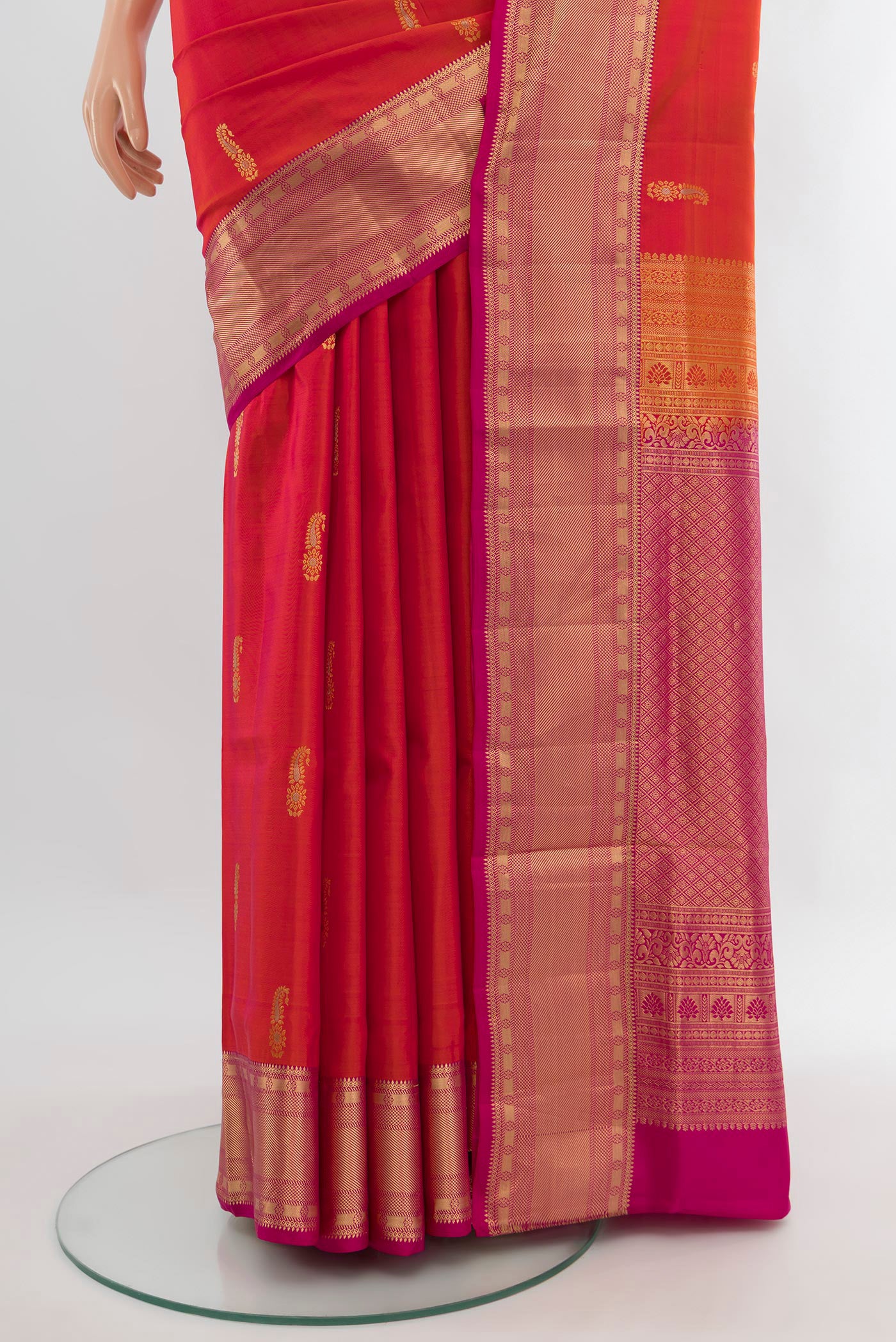 Pleats and pallu of Brick Orange Soft Silk Saree with Zari Butta on the body and Zari Border. 