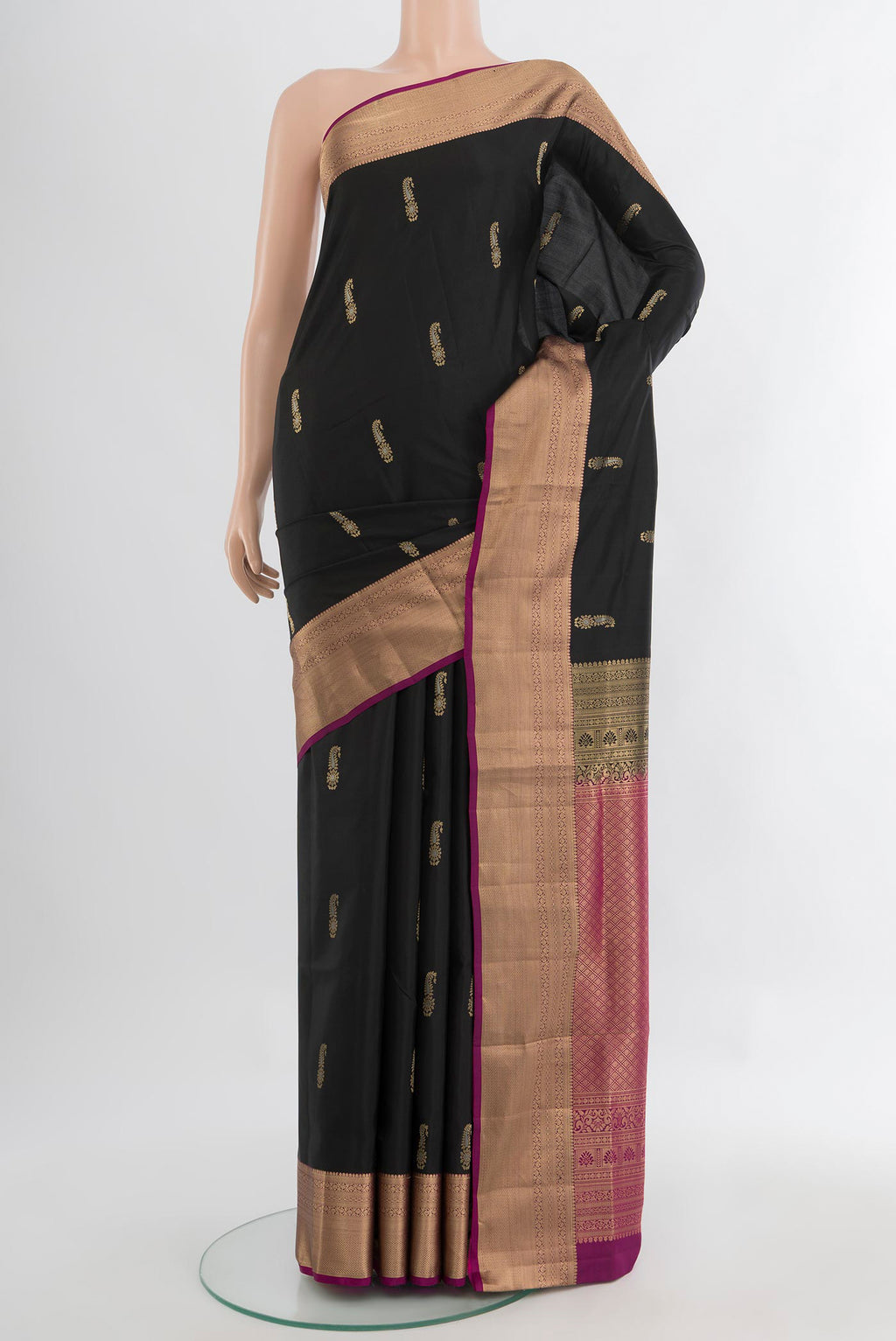 Black Soft Silk Saree with Zari Butta on the body and Silk Border.  displayed on a mannequin