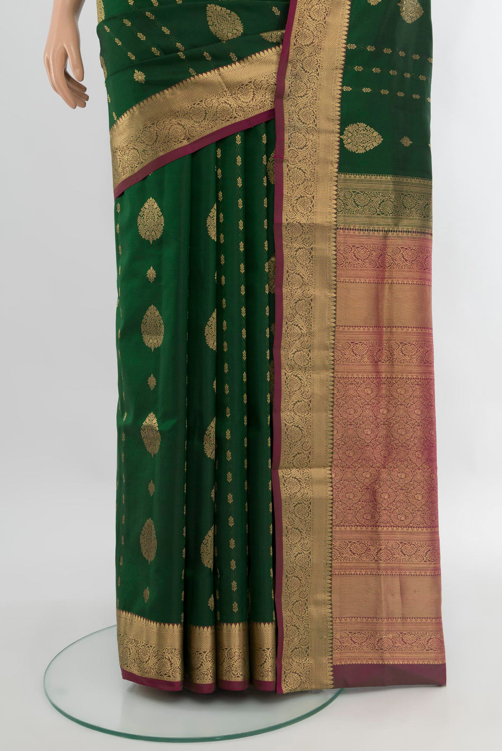 Pleats and pallu of Bottle Green Soft Silk Saree with Zari Butta on the body and Zari Border. 
