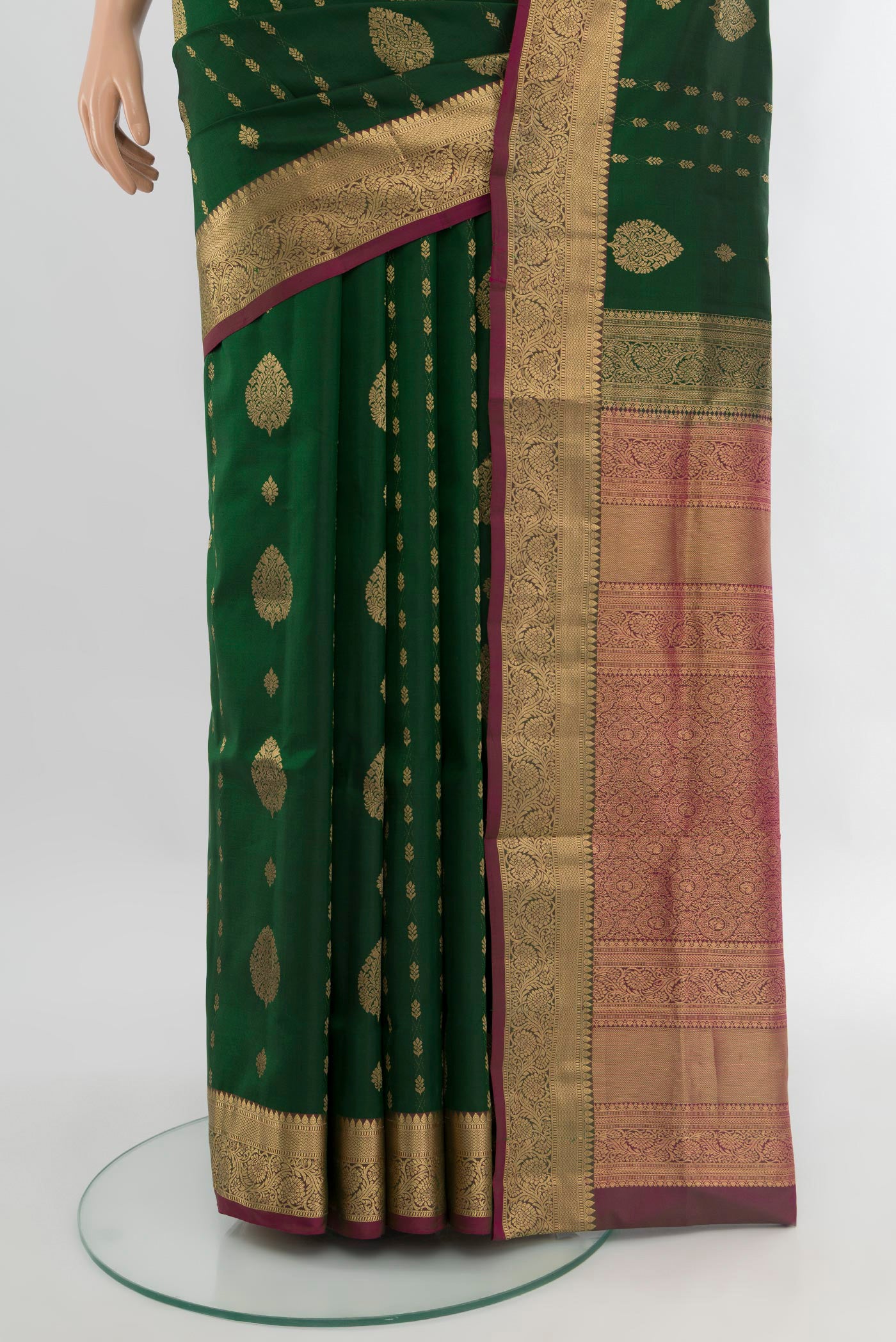 Pleats and pallu of Bottle Green Soft Silk Saree with Zari Butta on the body and Zari Border. 