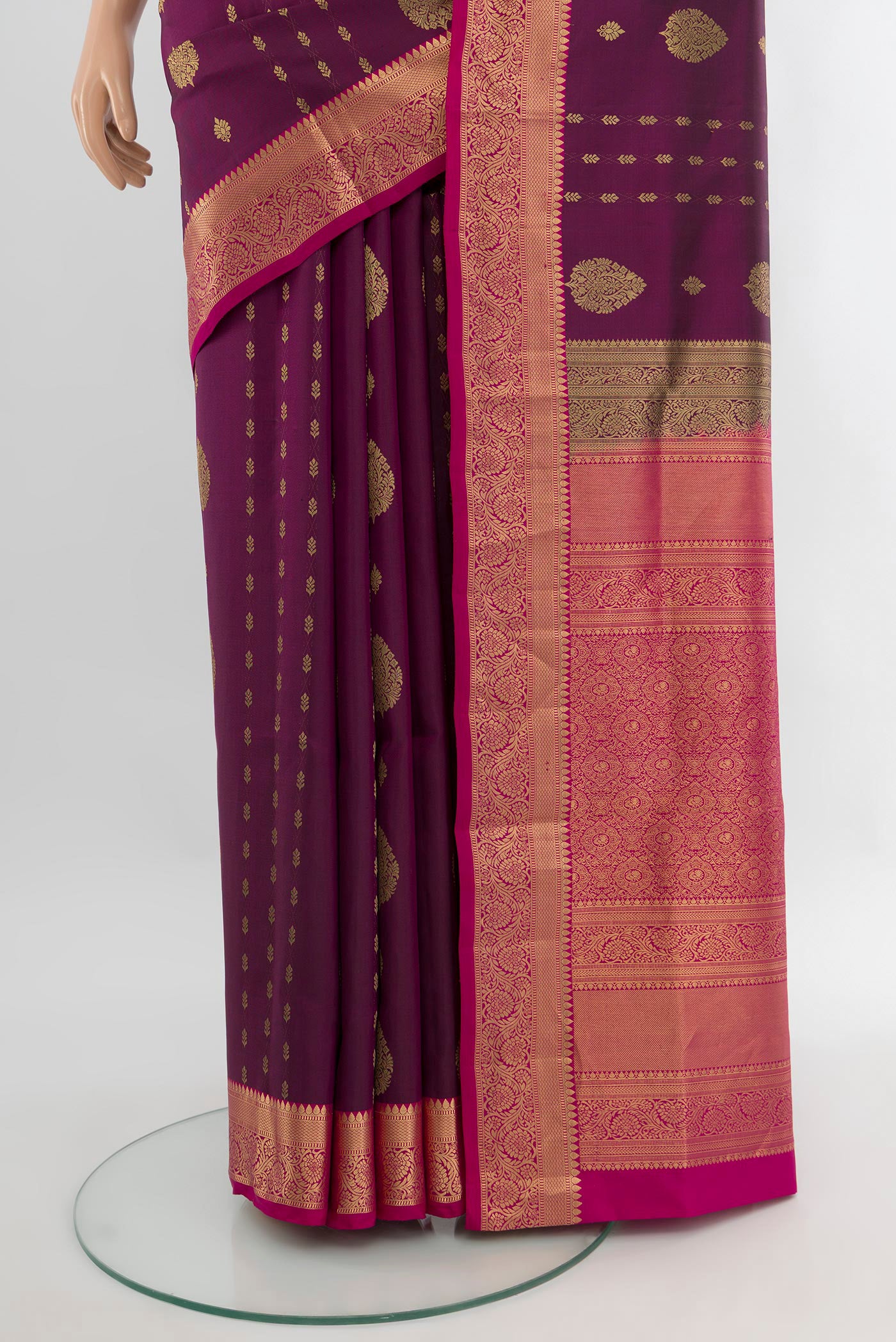 Pleats and pallu of Purple Soft Silk Saree with Zari Butta on the body and Zari Border. 
