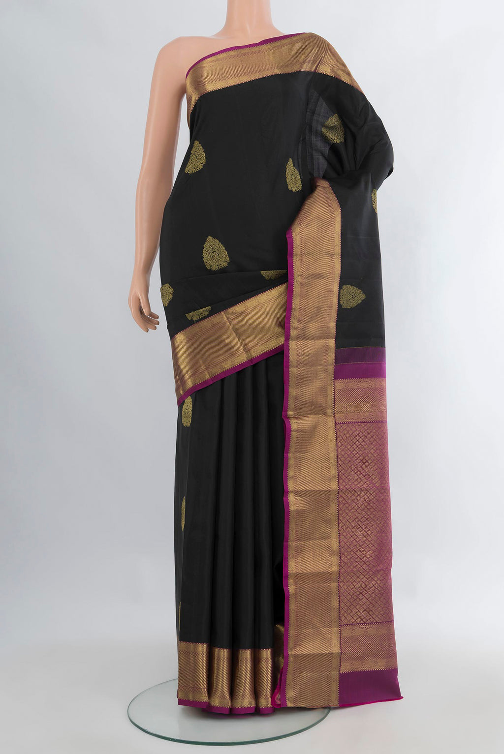 Pure Silk Black Kanchipuram Saree with Zari Butta on the body and Zari Border.  displayed on a mannequin