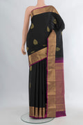 Pure Silk Black Kanchipuram Saree with Zari Butta on the body and Zari Border.  displayed on a mannequin