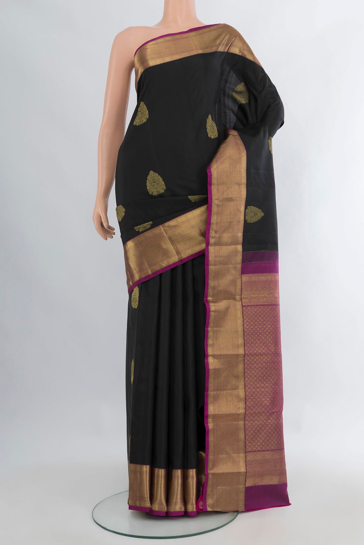 Pure Silk Black Kanchipuram Saree with Zari Butta on the body and Zari Border.  displayed on a mannequin
