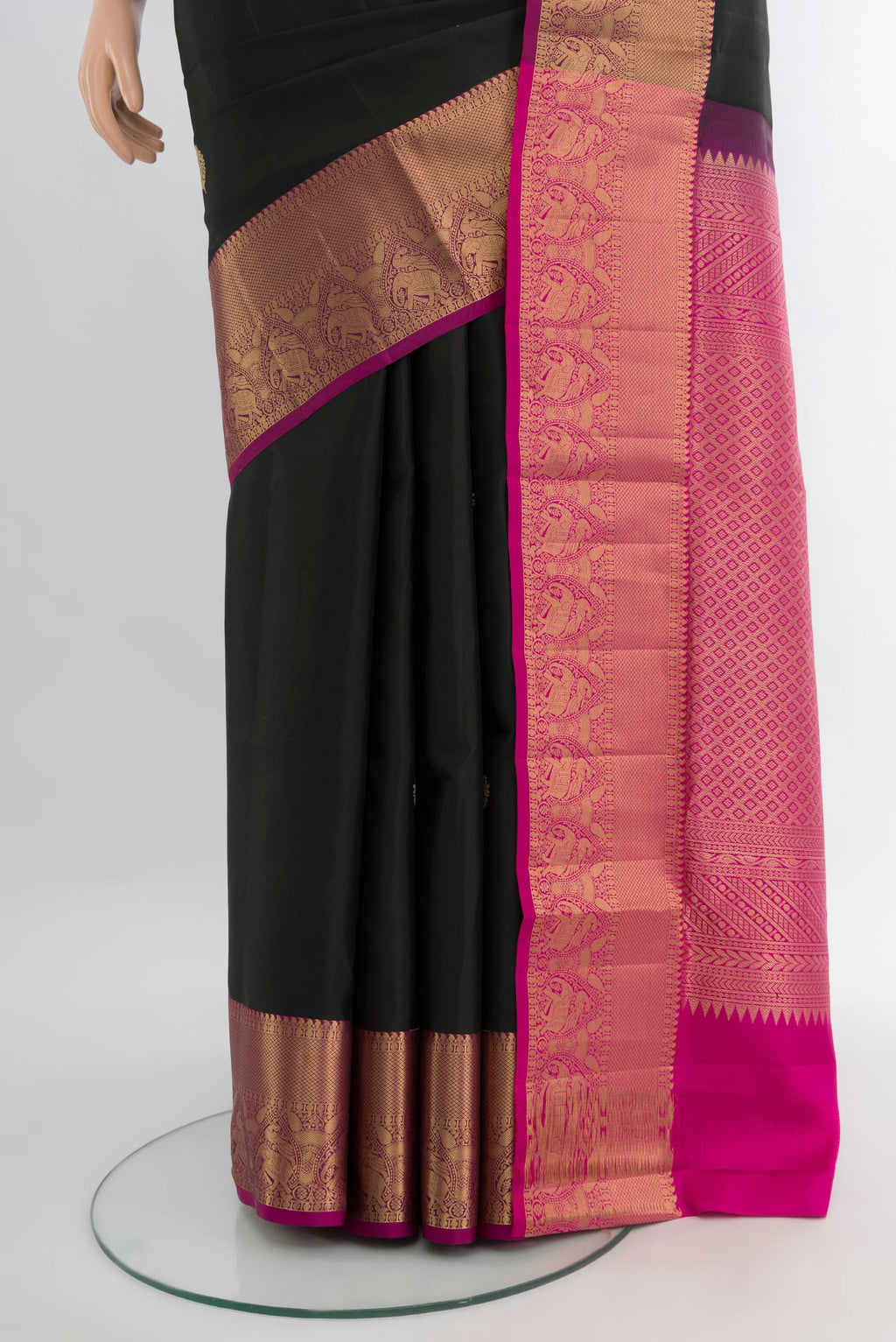 Pleats and pallu of Black Soft Silk Saree with Zari Butta on the body and Zari Border. 