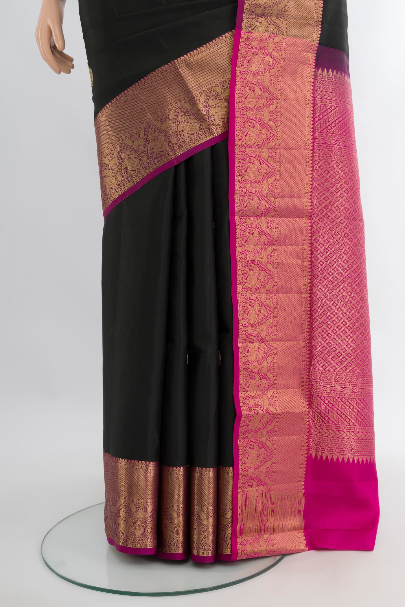 Pleats and pallu of Black Soft Silk Saree with Zari Butta on the body and Zari Border. 