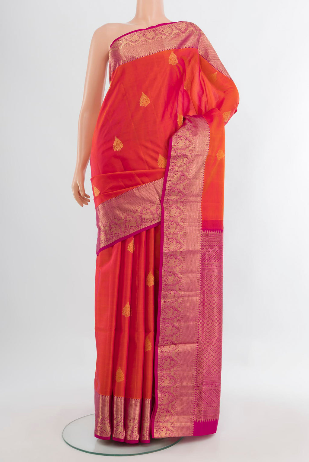 Peach Soft Silk Saree with Zari Butta on the body and Silk Border.  displayed on a mannequin