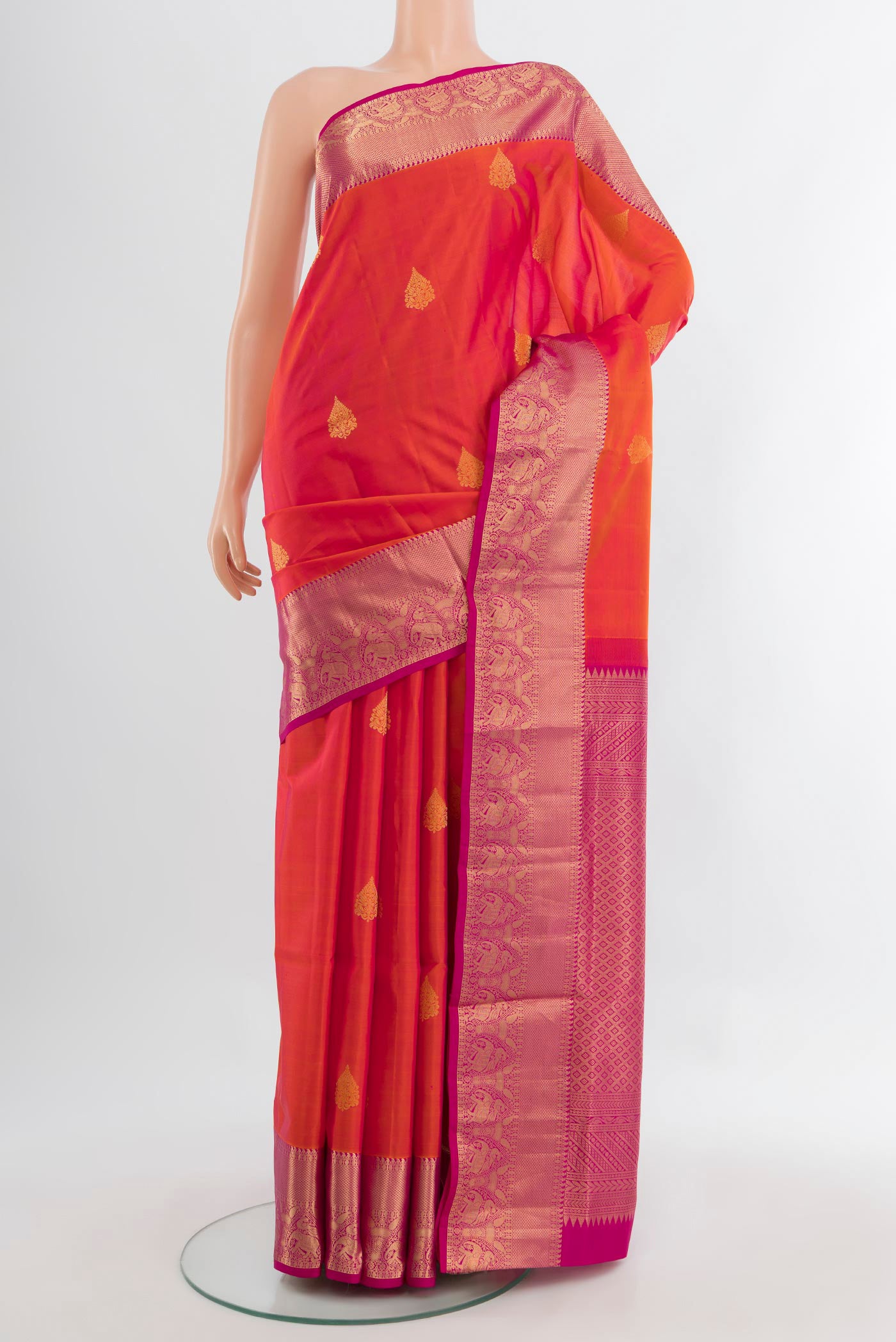 Peach Soft Silk Saree with Zari Butta on the body and Silk Border.  displayed on a mannequin