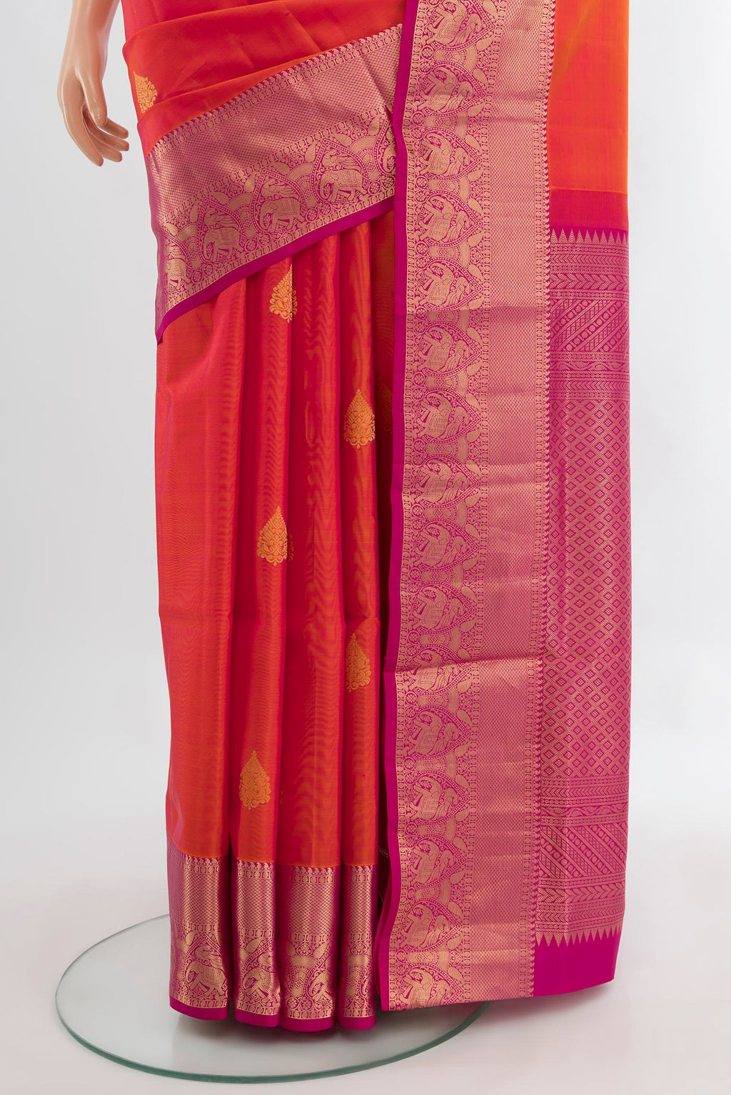 Pleats and pallu of Peach Soft Silk Saree with Zari Butta on the body and Silk Border. 