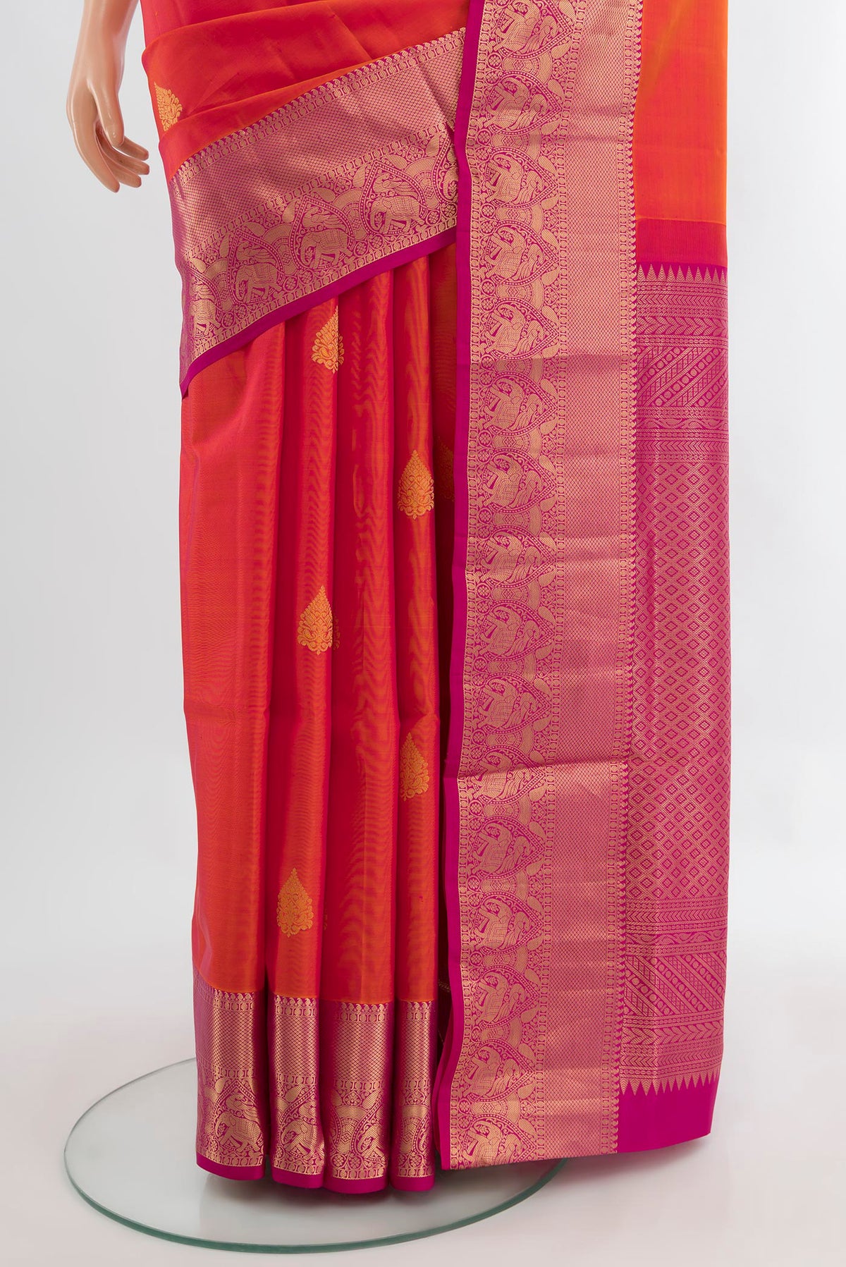 Pleats and pallu of Peach Soft Silk Saree with Zari Butta on the body and Silk Border. 