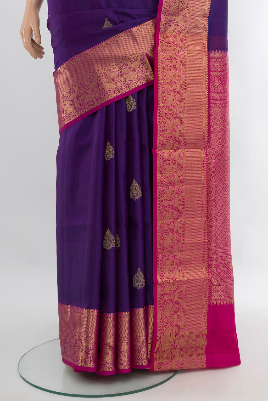 Pleats and pallu of Violet Soft Silk Saree with Zari Butta on the body and Zari Border. 