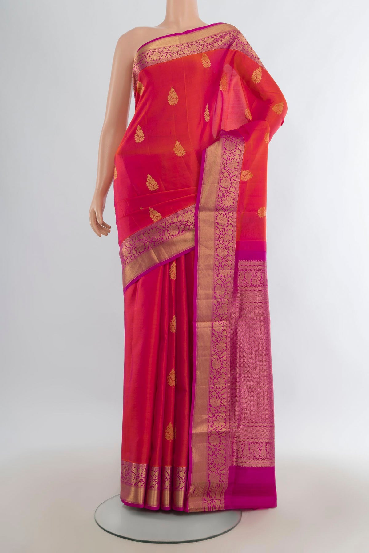 Pure Silk Brick Orange Dual Tone Soft Saree with Zari Butta on the body and Zari Border.  displayed on a mannequin