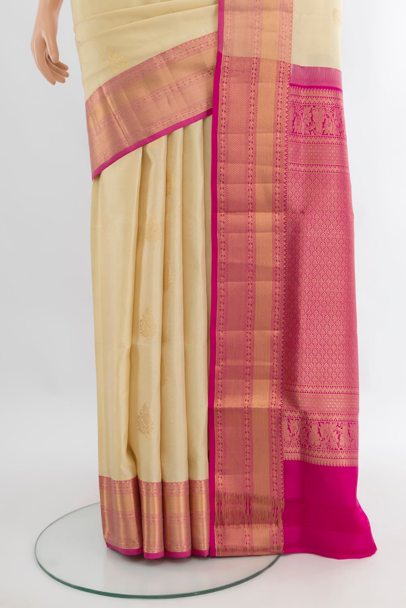 Pleats and pallu of Cream Soft Silk Saree with Zari Butta on the body and Zari Border. 