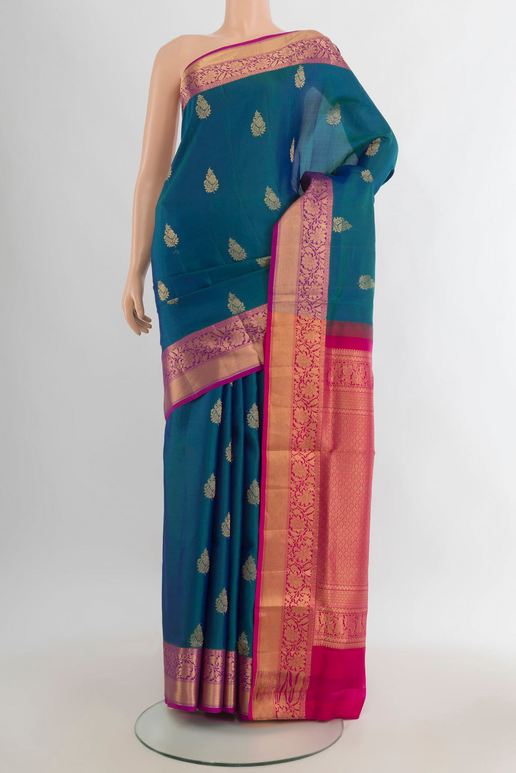 Pure Silk Peacock Blue Soft Saree with Zari Butta on the body and Zari Border.  displayed on a mannequin