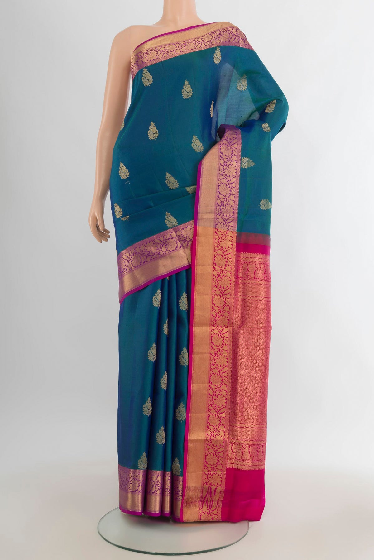Pure Silk Peacock Blue Soft Saree with Zari Butta on the body and Zari Border.  displayed on a mannequin