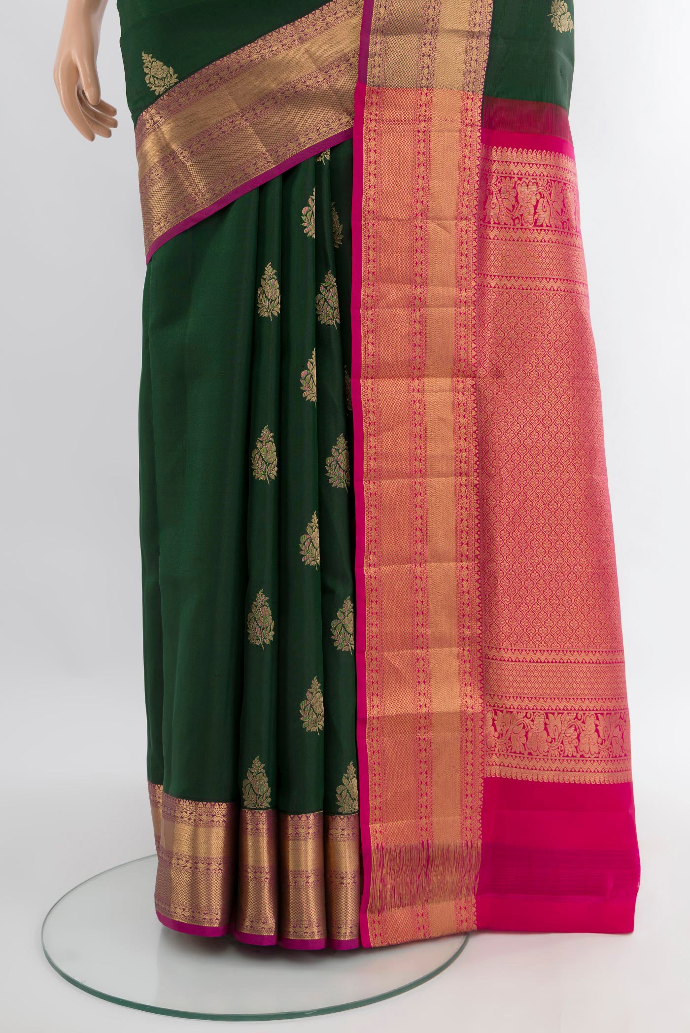 Pleats and pallu of Bottle Green Soft Silk Saree with Zari Butta on the body and Zari Border. 