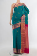Pure Silk Peacock Blue Soft Saree with Zari Butta on the body and Zari Border.  displayed on a mannequin