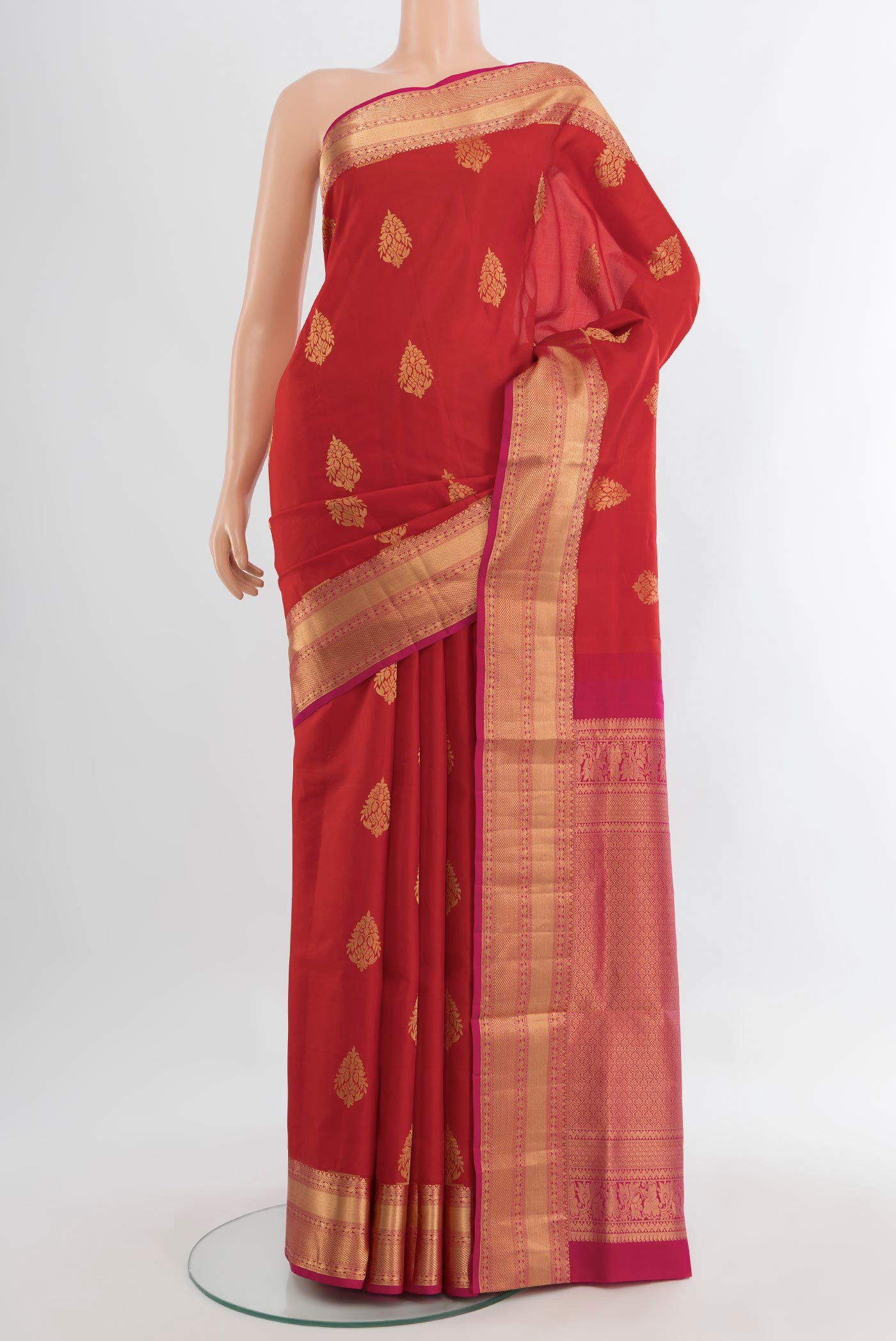 Red Soft Silk Saree with Zari Butta on the body and Silk Border.  displayed on a mannequin