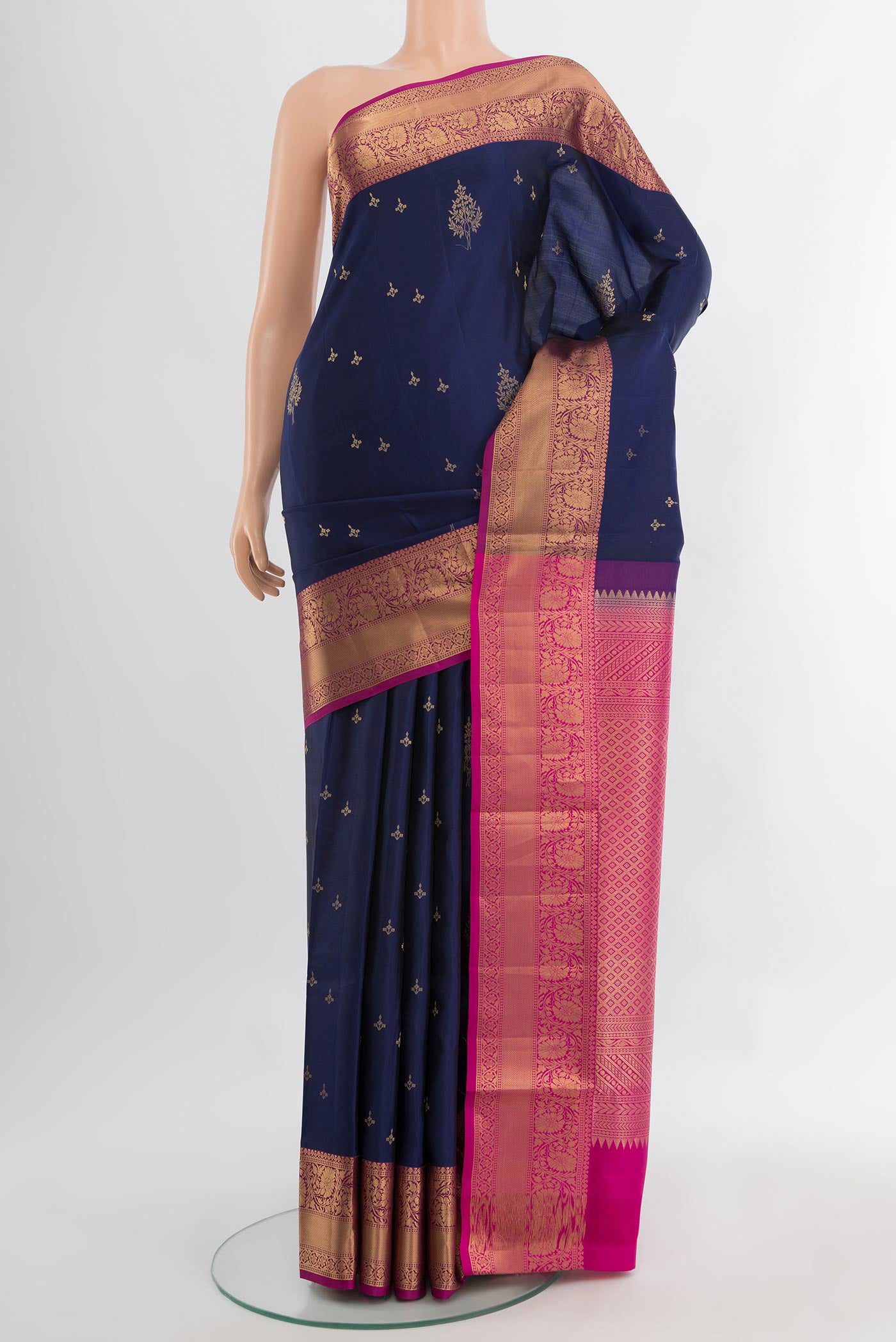 Navy Blue Soft Silk Saree with Zari Butta on the body and Silk Border.  displayed on a mannequin
