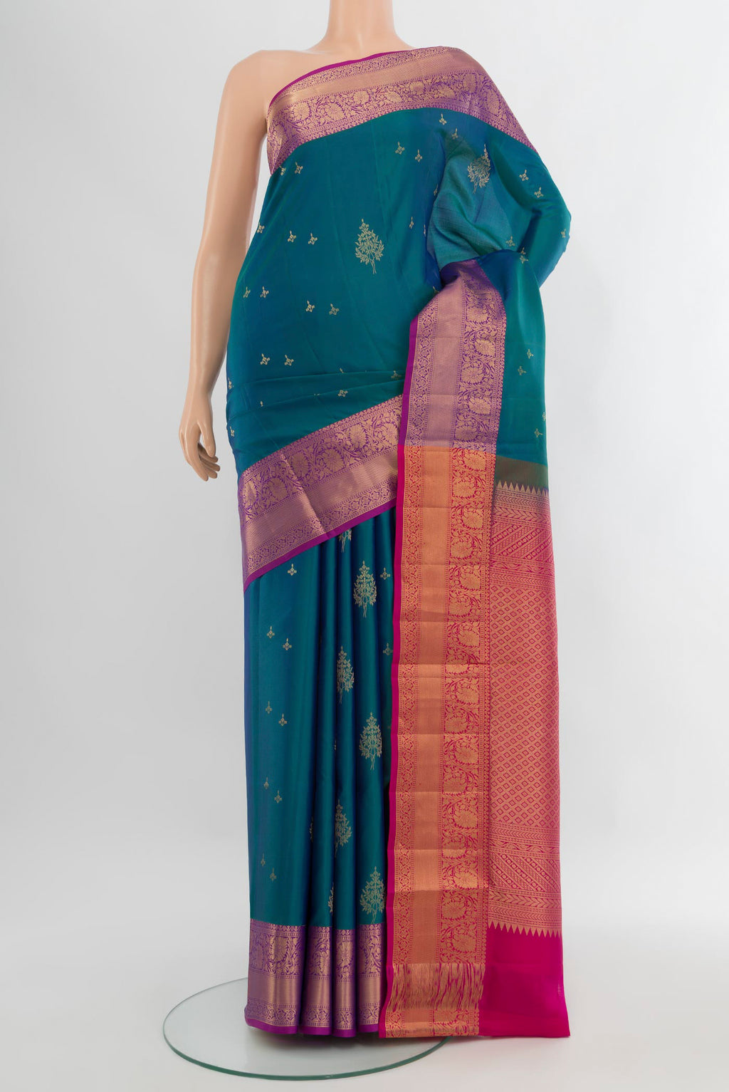 Peacock Blue Soft Silk Saree with Zari Butta on the body and Zari Border.  displayed on a mannequin