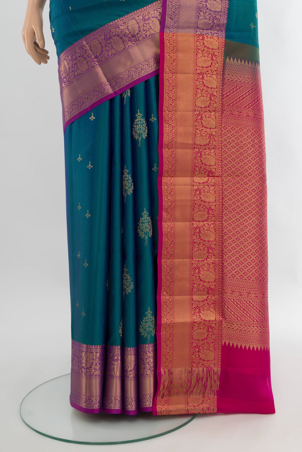Pleats and pallu of Peacock Blue Soft Silk Saree with Zari Butta on the body and Zari Border. 