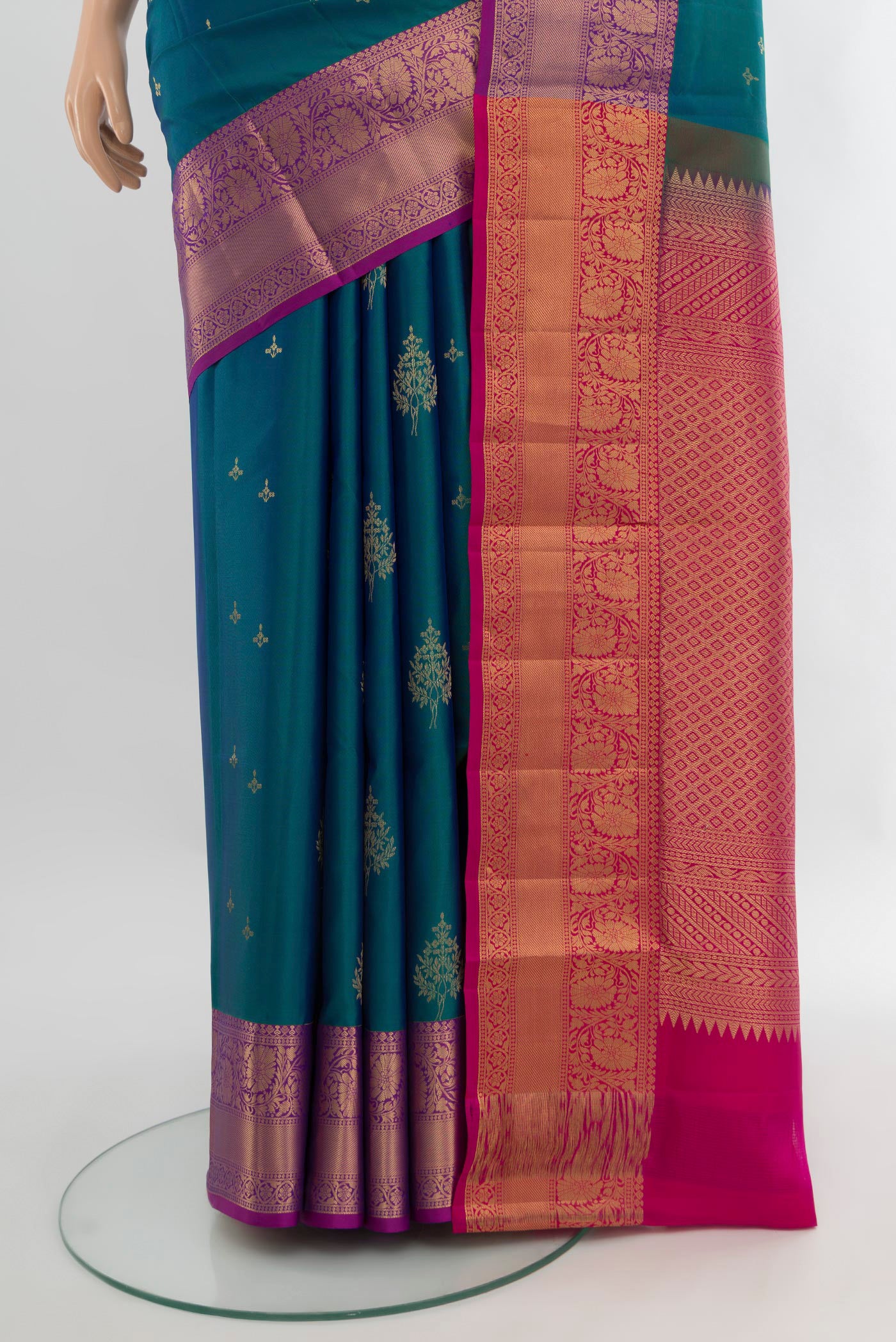 Pleats and pallu of Peacock Blue Soft Silk Saree with Zari Butta on the body and Zari Border. 