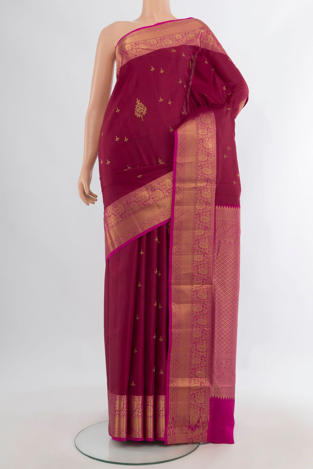 Pure Silk Maroon Soft Saree with Zari Butta on the body and Zari Border.  displayed on a mannequin