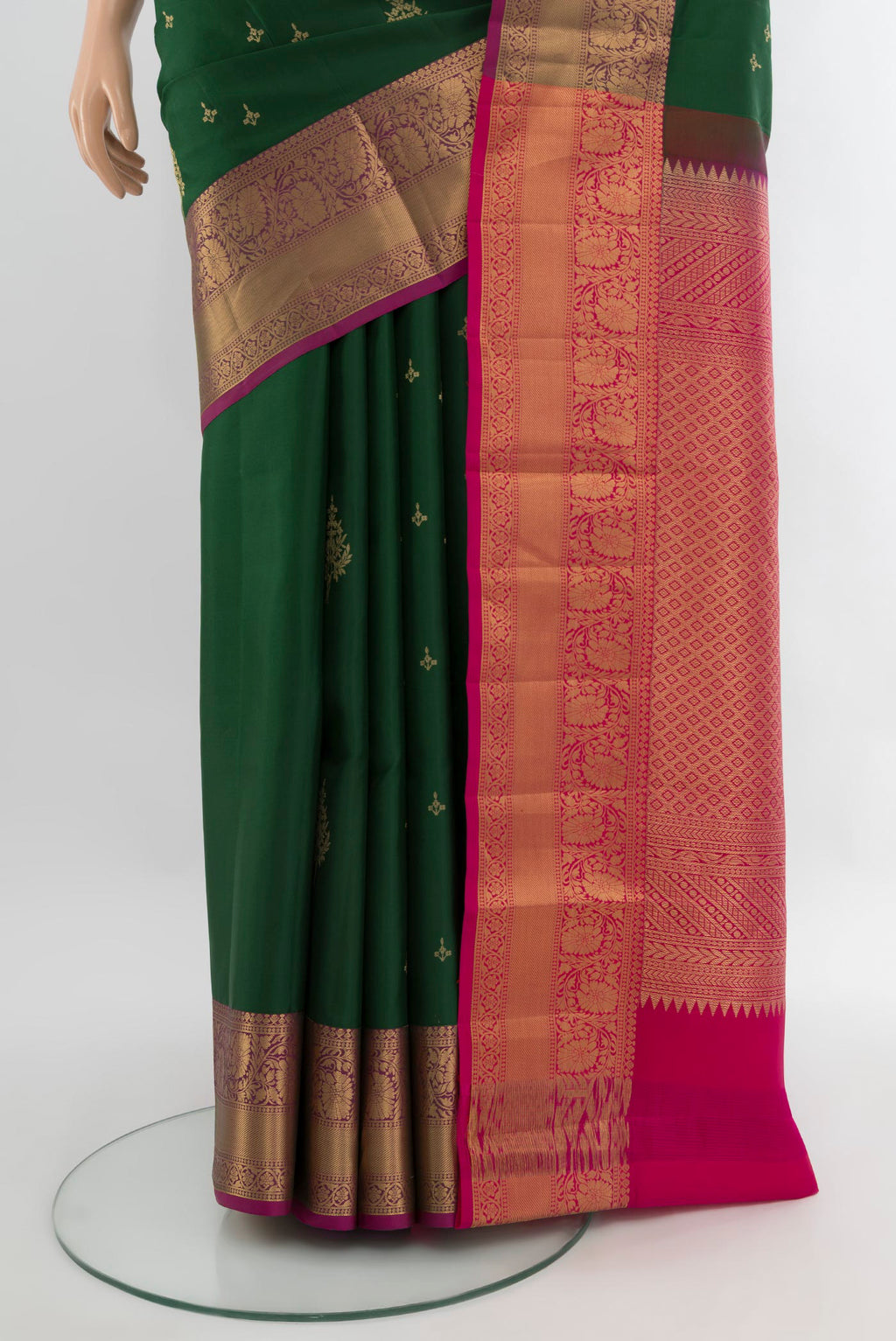 Pleats and pallu of Bottle Green Soft Silk Saree with Zari Butta on the body and Zari Border. 