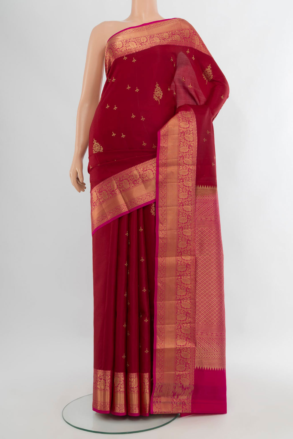 Maroon Soft Silk Saree with Zari Butta on the body and Zari Border.  displayed on a mannequin