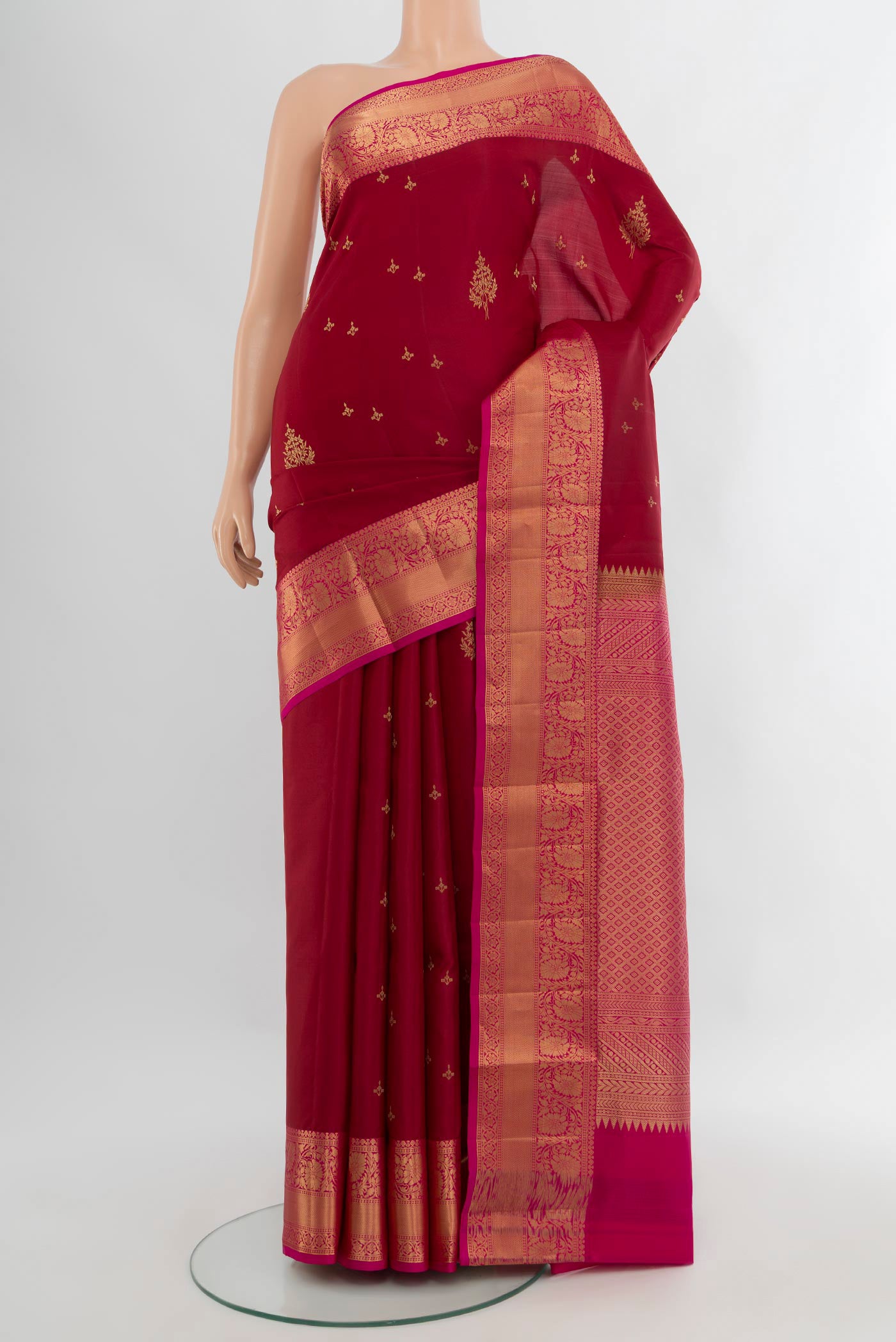 Maroon Soft Silk Saree with Zari Butta on the body and Zari Border.  displayed on a mannequin