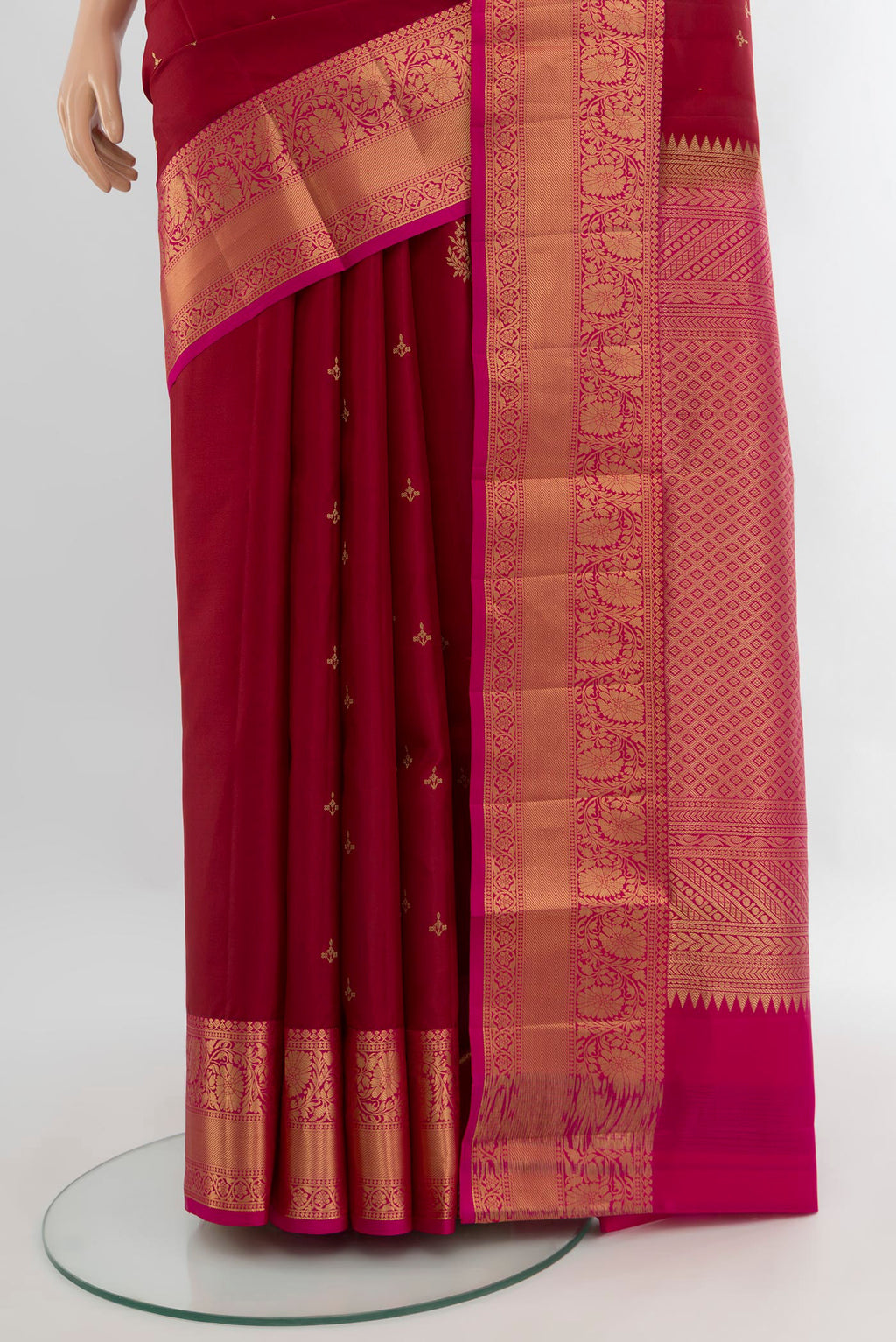 Pleats and pallu of Maroon Soft Silk Saree with Zari Butta on the body and Zari Border. 