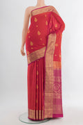Peach Soft Silk Saree with Zari Butta on the body and Silk Border.  displayed on a mannequin