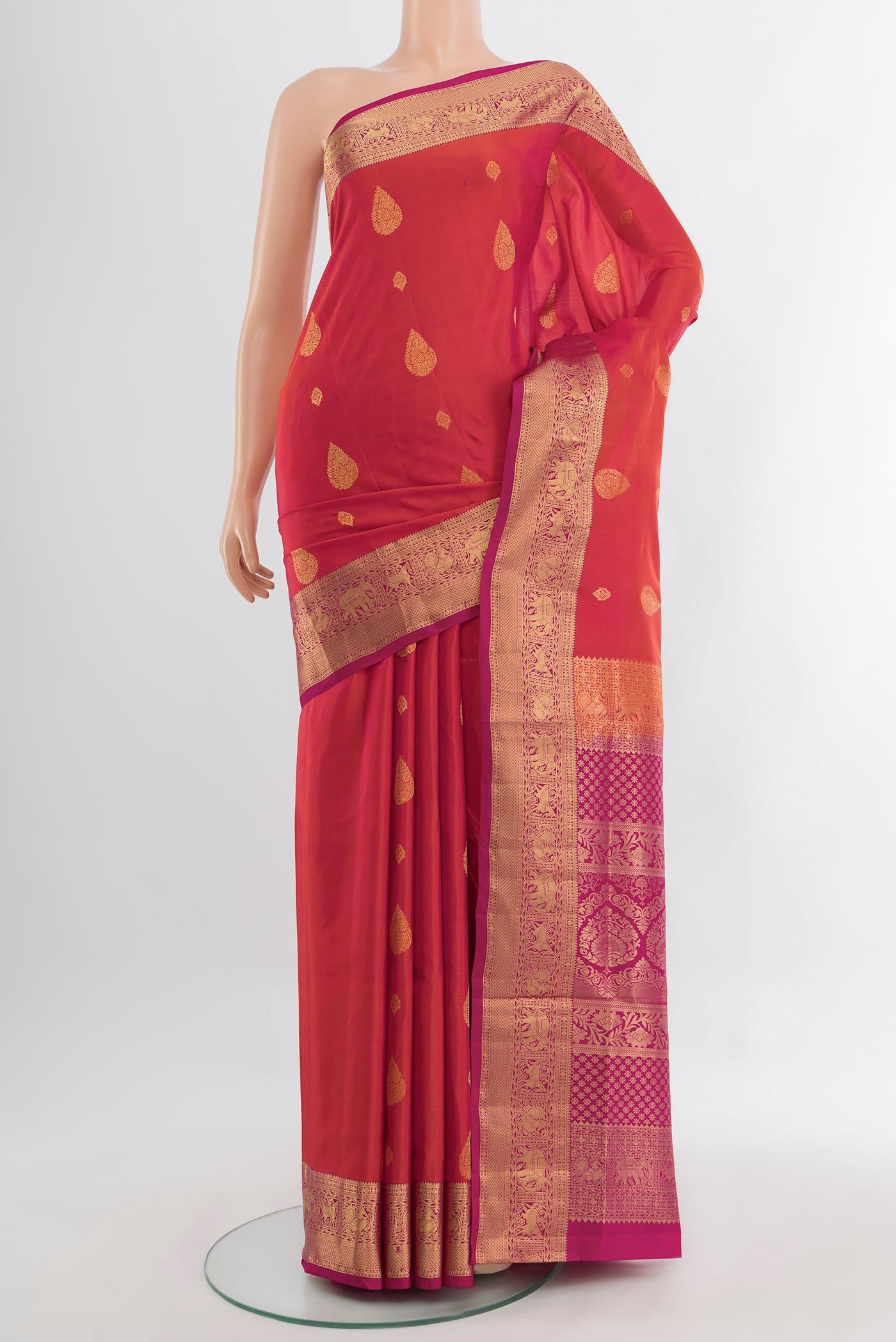 Peach Soft Silk Saree with Zari Butta on the body and Silk Border.  displayed on a mannequin