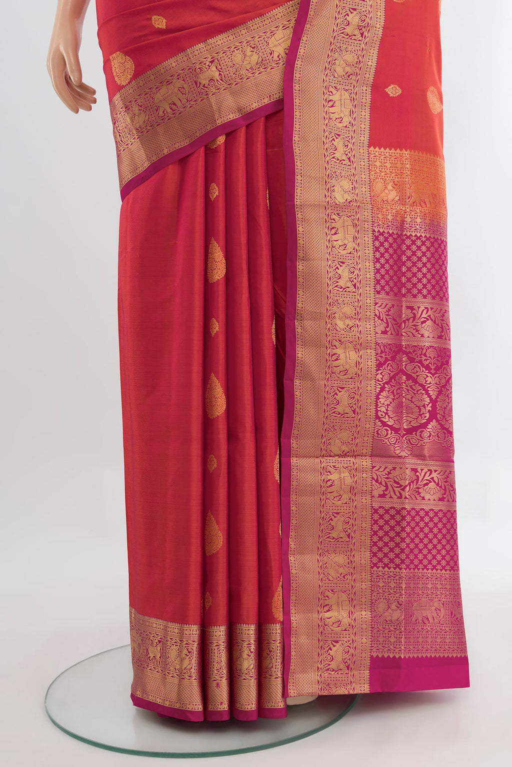 Pleats and pallu of Peach Soft Silk Saree with Zari Butta on the body and Silk Border. 