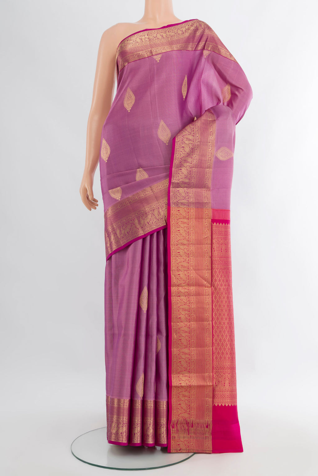 Lavender Soft Silk Saree with Zari Butta on the body and Zari Border.  displayed on a mannequin