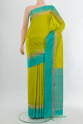 Parrot Green Soft Silk Saree with Zari Butta on the body and Silk Border.  displayed on a mannequin