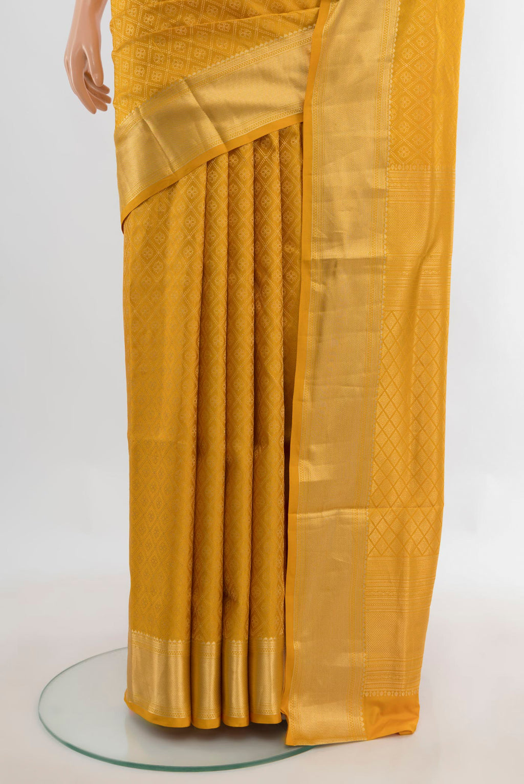 Pleats and pallu of Pure Silk Yellow Soft Saree with Zari Brocade on the body and Zari Border. 