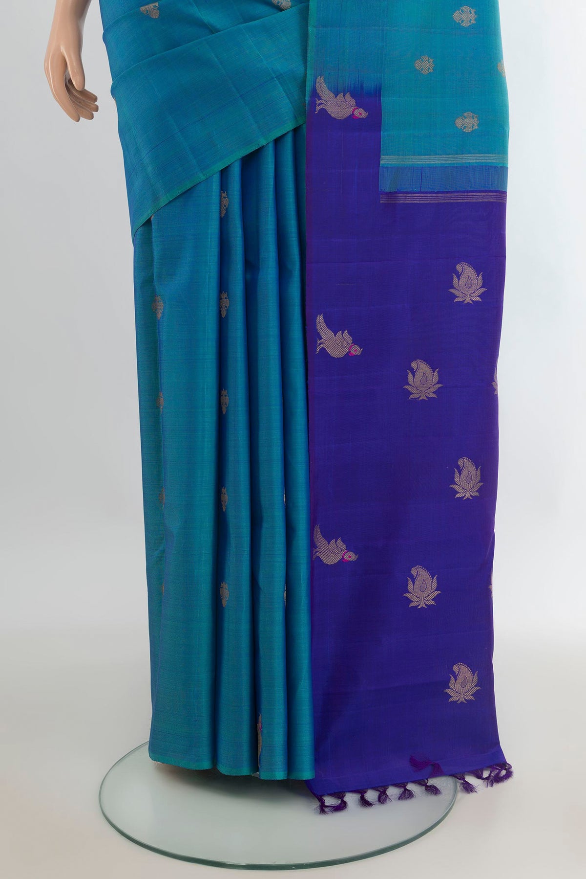 Pleats and pallu of Pure Silk Peacock Blue Kanchipuram Saree with Zari Butta on the body and Without Border. 