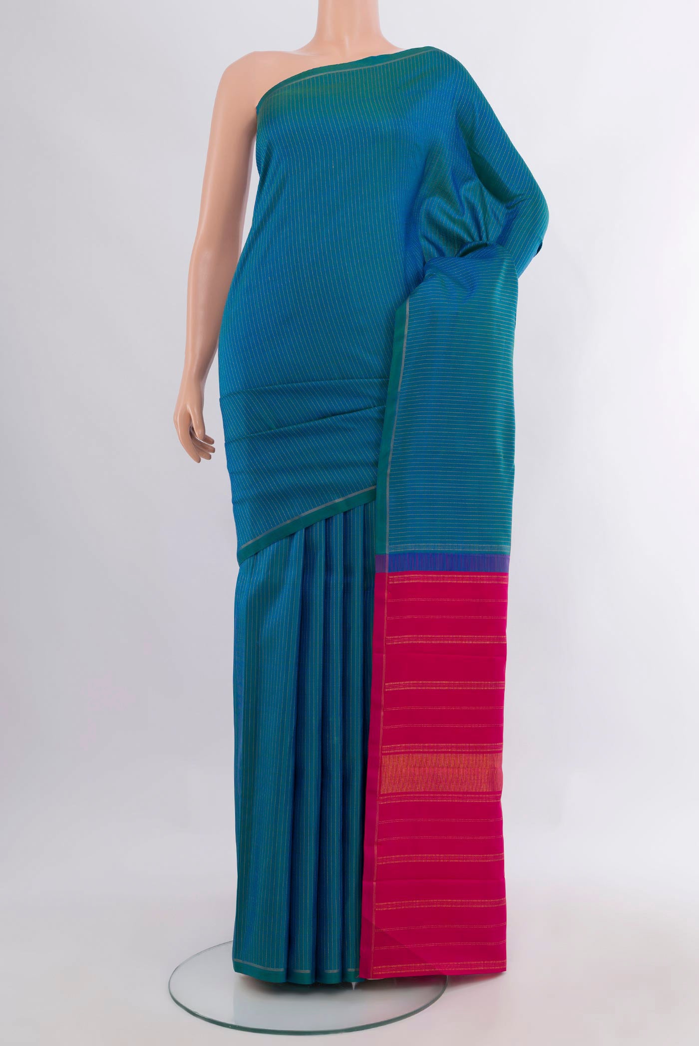 Pure Silk Pure Zari Peacock Blue Kanjivaram Saree with Stripes on the body and Thin Zari Line.  displayed on a mannequin