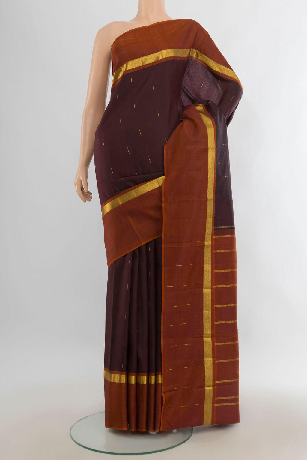 Pure Silk Pure Zari Coffee Brown Kanchipuram Saree with Zari Butta on the body and Silk Border.  displayed on a mannequin