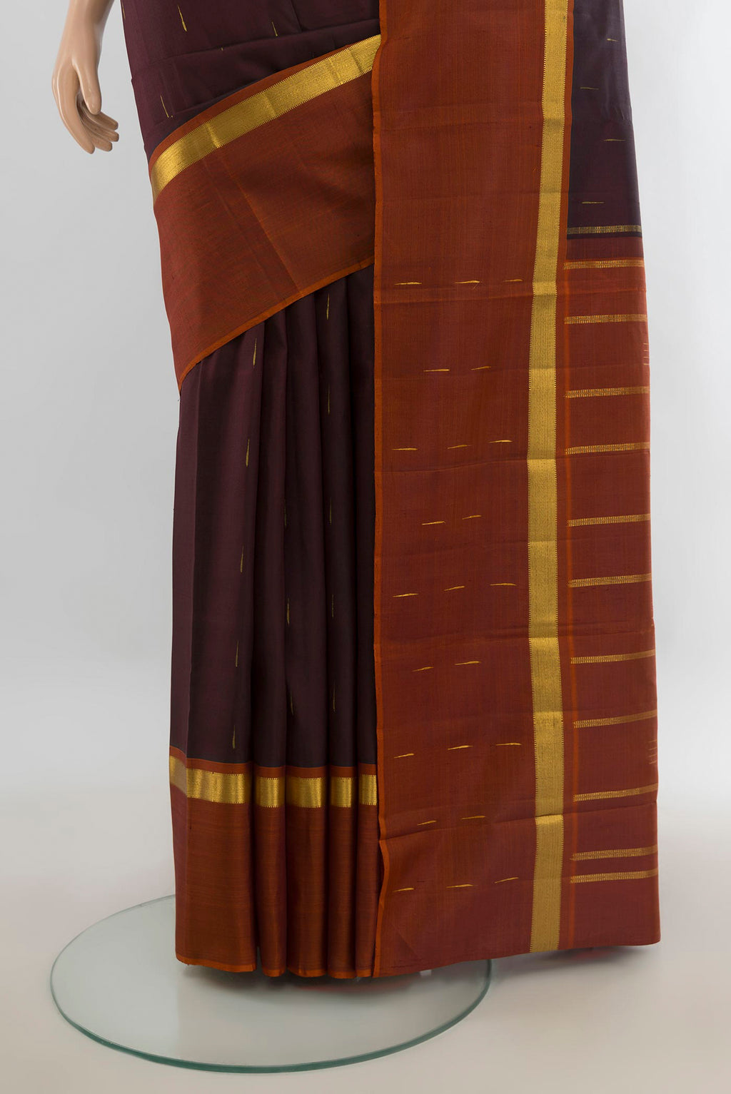 Pleats and pallu of Pure Silk Pure Zari Coffee Brown Kanchipuram Saree with Zari Butta on the body and Silk Border. 