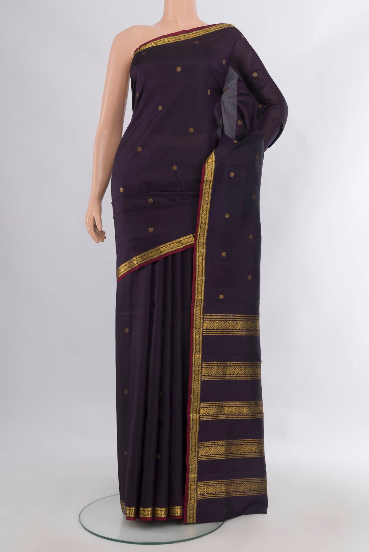 Pure Silk Navy Blue Kanchipuram Saree with Zari Butta on the body and Zari Border.  displayed on a mannequin