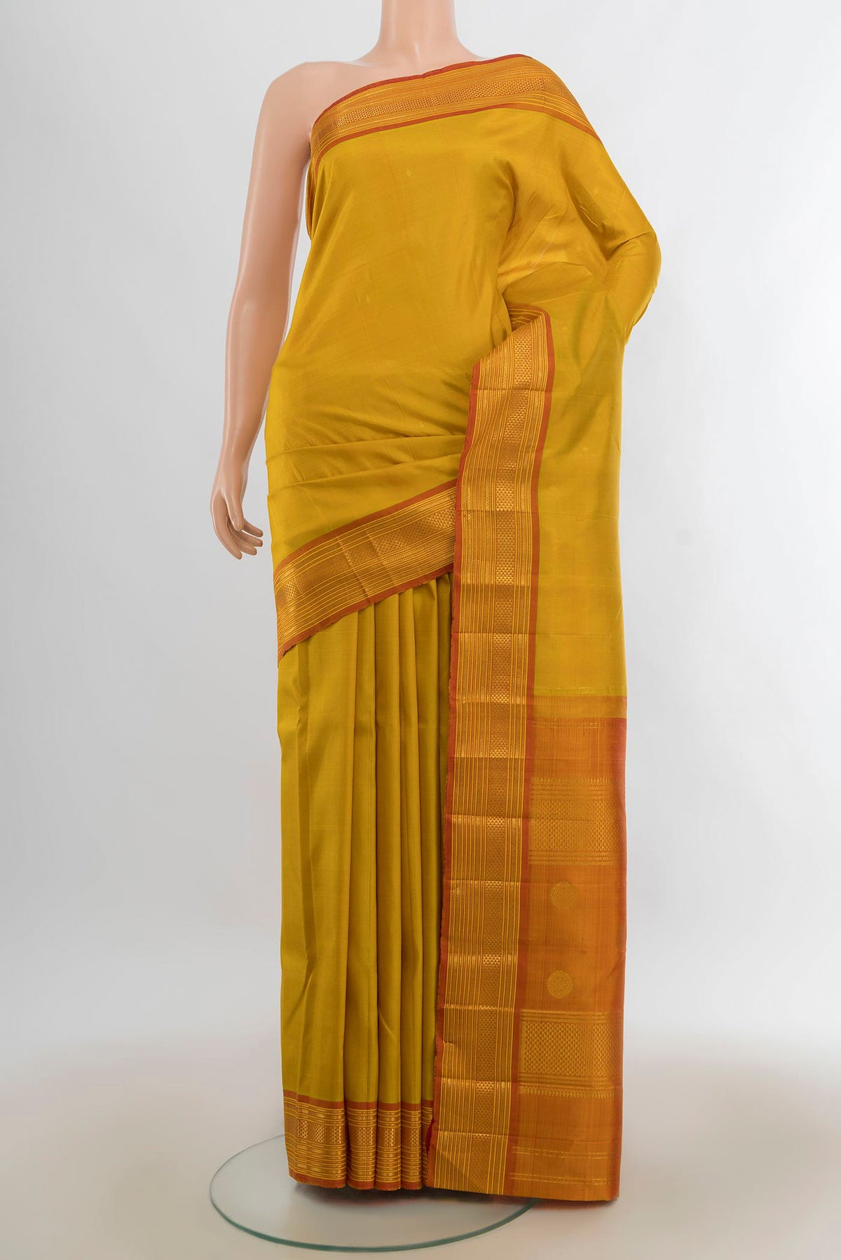 Pure Silk Mustard Kanchipuram Saree with Zari Butta on the body and Silk Border.  displayed on a mannequin