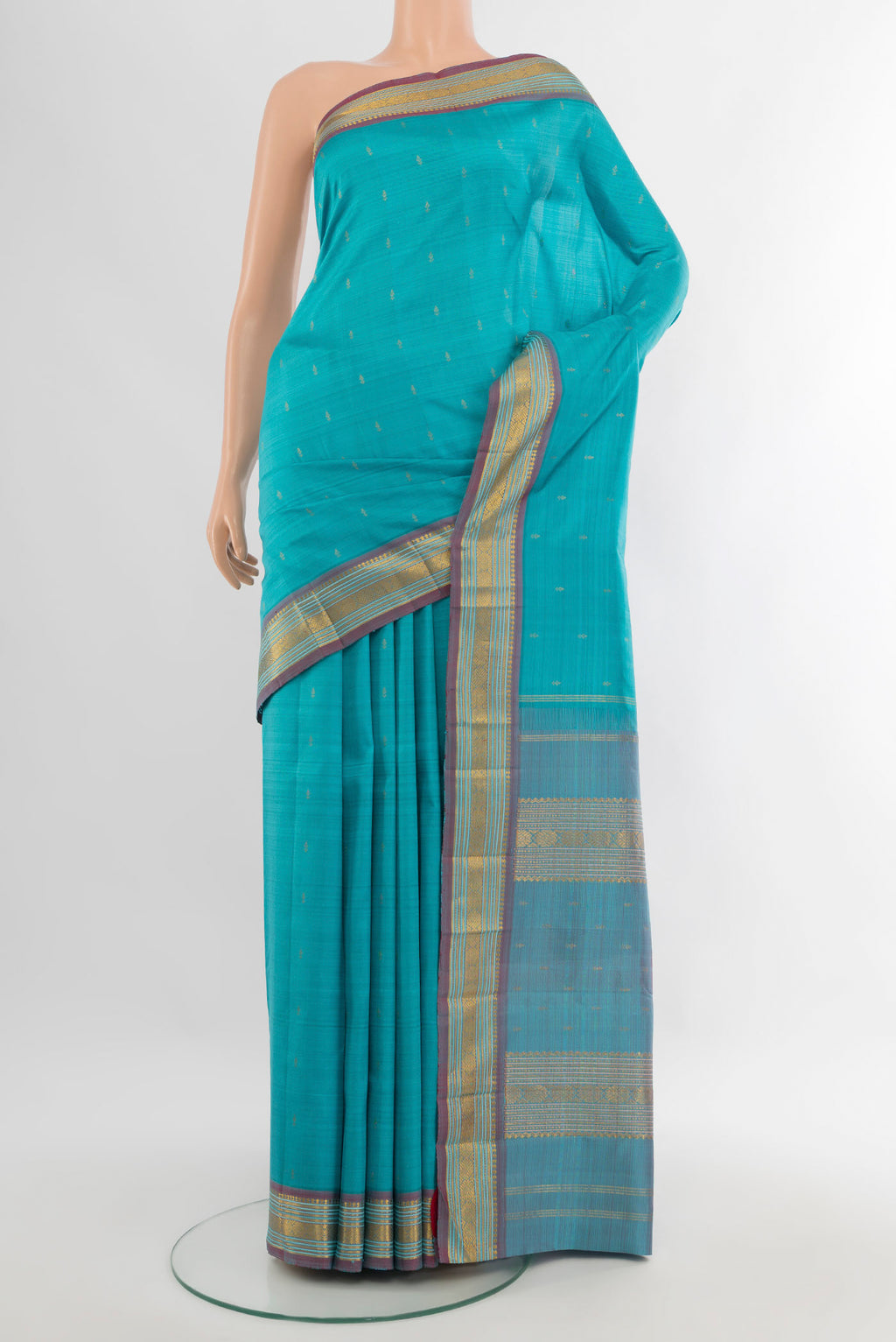 Light Blue Kanchipuram Silk Saree with Zari Butta on the body and Zari Border.  displayed on a mannequin